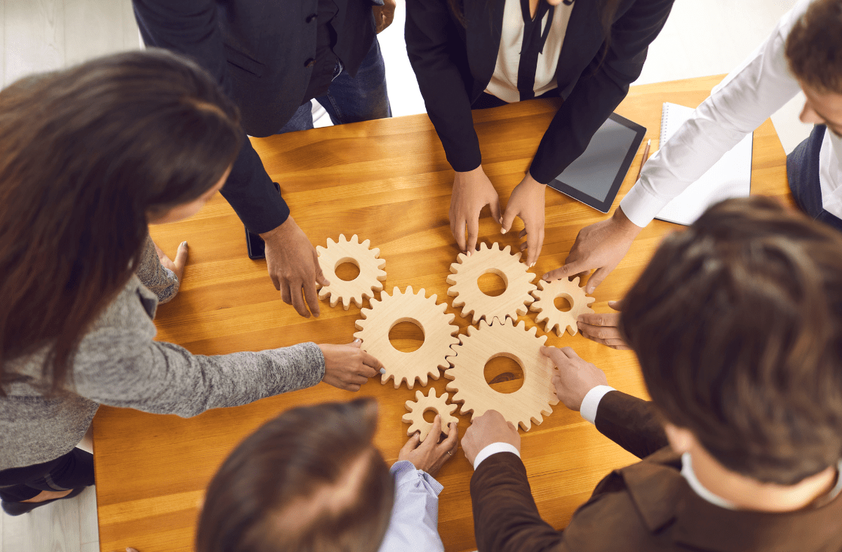 a group of business people working together on a wooden table