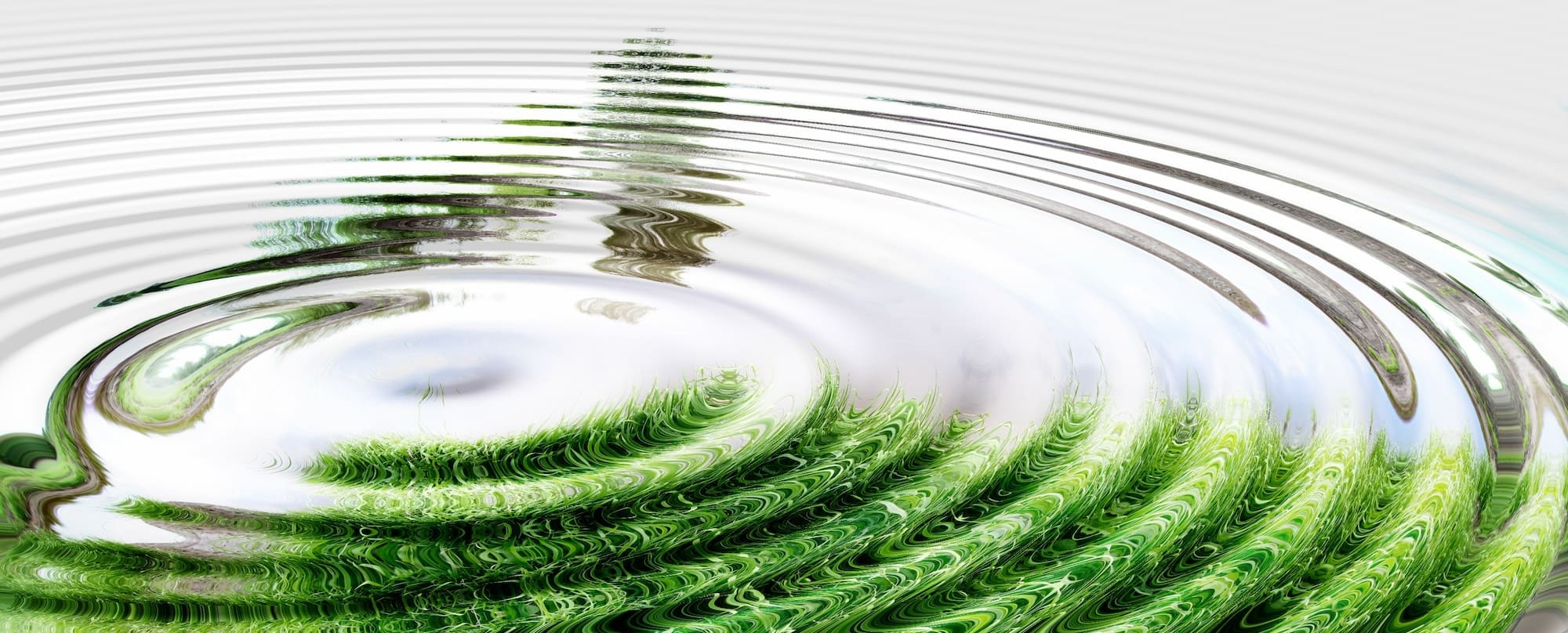Ripple effect of water with a green reflection.