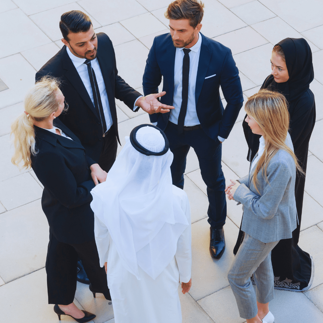 five business people talking to each other