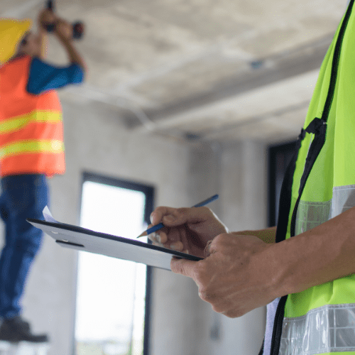 Construction site inspector conducting safety and compliance checks to manage supplier risk, contractor management, and supply chain risk management.