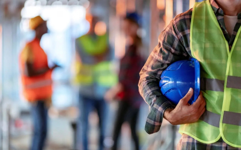Miner with hard hat under arm