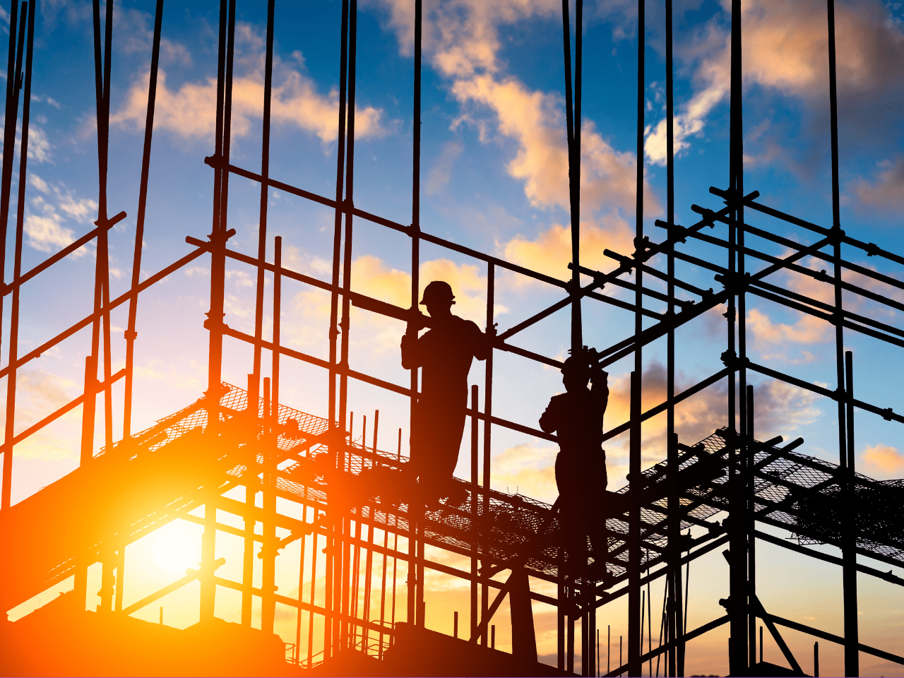 Construction workers assembling scaffolding on site during sunrise in Australia, highlighting worksite safety and contractor management.